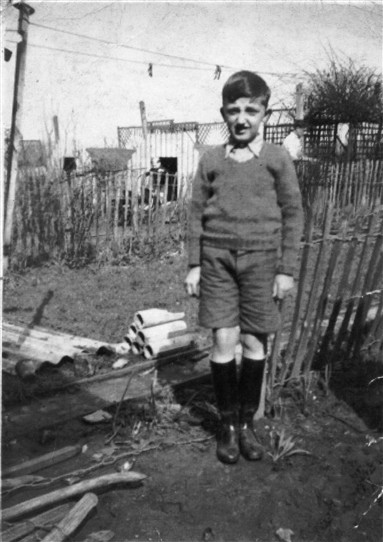 Photo:James Jackson in garden of Peterborough Road (1940) next to the Brown's fence.  Next to broken drain from Andersen shelter.