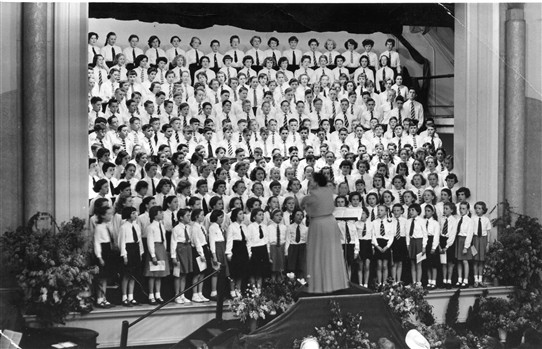 Photo:Isabel Bailey a famous Opera Singer conducting school choirs from the surrounding area, at a hall in Carshalton. Sylvia is in the 3rd row from the top clearly visible on left with pony tail.